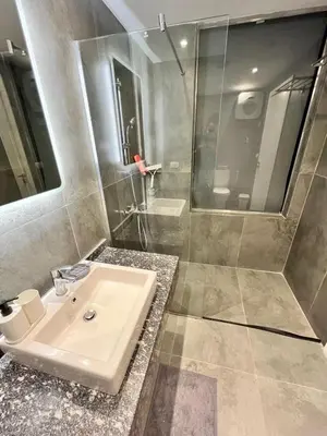 a bathroom with a sink and a shower at 2BR Ground Floor Apartment with Heated Pool in Bali El Gouna in Hurghada