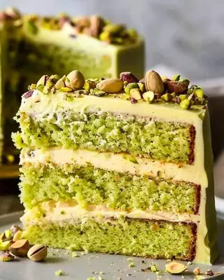 a three layer cake with nuts on top of it at فندق نايل ايليت سوهاج in Qilfāw