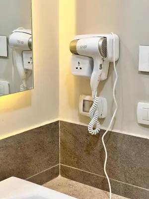 a hair dryer on a wall in a bathroom at Cyan Lakefront 3BR Townhouse El Gouna in Hurghada