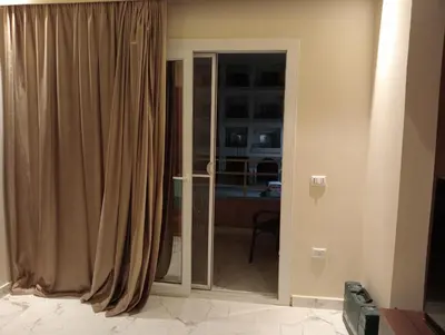 a room with a sliding glass door with a window at Luxury Flat 3 rooms in Hurghada