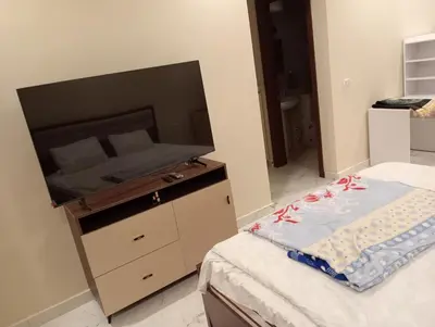 a bedroom with a bed with a large flat screen tv at Luxury Flat 3 rooms in Hurghada