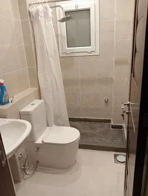 a bathroom with a toilet and a sink and a shower at Luxury Flat 3 rooms in Hurghada