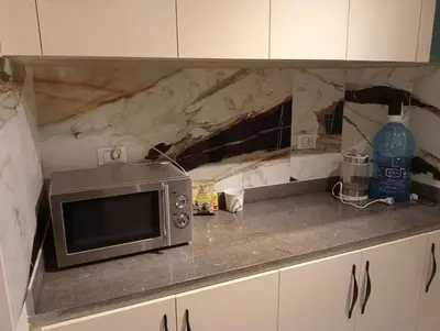 a microwave sitting on a counter in a kitchen at Luxury Flat 3 rooms in Hurghada
