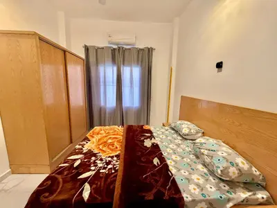 a bedroom with a bed with a bedspread on it at Anubis Guesthouse in Luxor