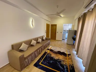 a living room with a couch in a room at Anubis Guesthouse in Luxor