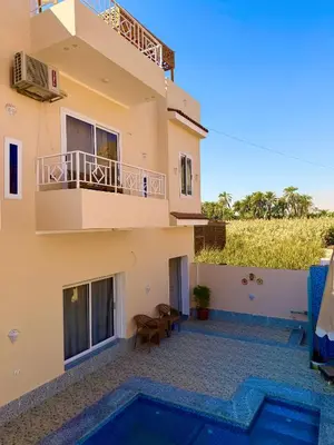 a villa with a view of a house at Anubis Guesthouse in Luxor