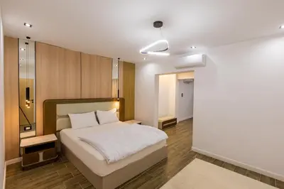 a bedroom with a white bed and a mirror at private villa in Hurghada