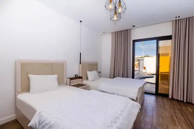 a hotel room with two beds and a window at private villa in Hurghada