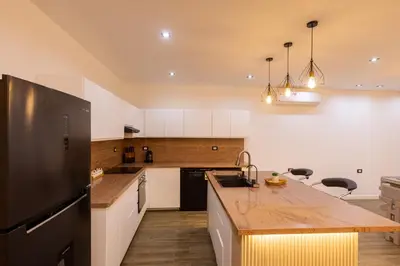 a kitchen with a wooden counter top and a kitchen island at private villa in Hurghada
