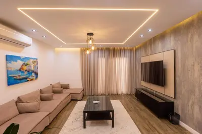 a living room with a couch and a tv at private villa in Hurghada