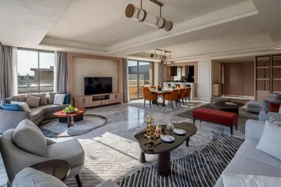 a living room with a couch and a table at Rixos Premium Magawish Bay View in Hurghada