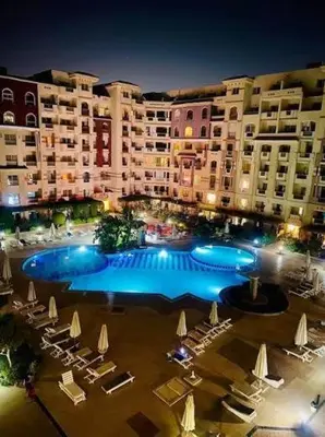 a large swimming pool in front of a large building at florenza khamsin resort hurghada in Hurghada