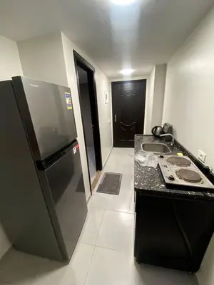a kitchen with a black refrigerator and a sink at florenza khamsin resort hurghada in Hurghada
