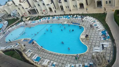 an overhead view of a swimming pool in a resort at Sea View Apartment Inside Gravity Hotel in Hasheesh Plain in Hurghada