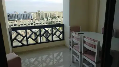 a balcony with a table and chairs and a view at Sea View Apartment Inside Gravity Hotel in Hasheesh Plain in Hurghada