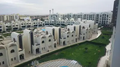 an aerial view of a large white building at Sea View Apartment Inside Gravity Hotel in Hasheesh Plain in Hurghada