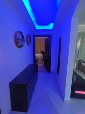 a living room with blue lights on the ceiling at Sea View Apartment Inside Gravity Hotel in Hasheesh Plain in Hurghada