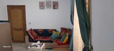 a living room with a couch with colorful pillows at Sea Breeze in Hurghada