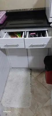 a white cabinet with two drawers and a rug at Sea Breeze in Hurghada