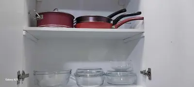 a shelf with pots and glasses in a kitchen at Sea Breeze in Hurghada