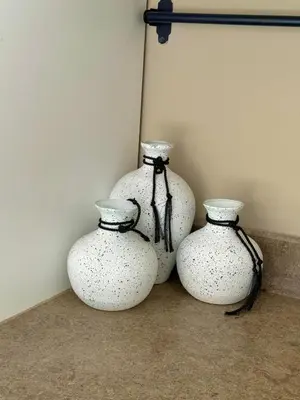 four white vases sitting next to a wall at Elegant 2BR Apartment Heated Pool El Gouna in Hurghada