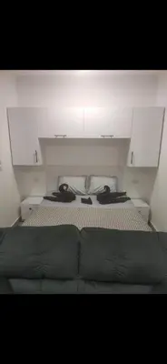 a bedroom with a bed and white cabinets at Princess Resort Lovely Studio in Hurghada