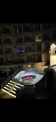 a building with a fountain in front of a building at Princess Resort Lovely Studio in Hurghada