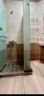 a shower with a glass door in a bathroom at Princess Resort Lovely Studio in Hurghada