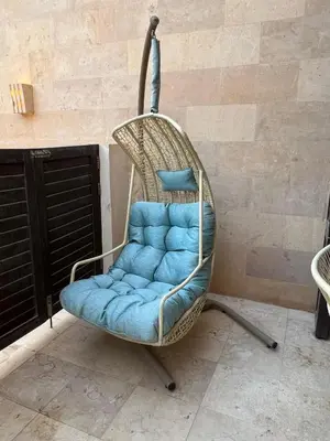 a swing chair with a blue seat in a room at Ground Floor 1 Bedroom Scrub Unit in El Gouna in Hurghada