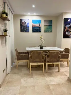 a dining room with a table and chairs at Ground Floor 1 Bedroom Scrub Unit in El Gouna in Hurghada