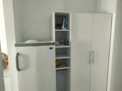 a white refrigerator in a kitchen next to white cabinets at Sherathon studio Sheri in Hurghada