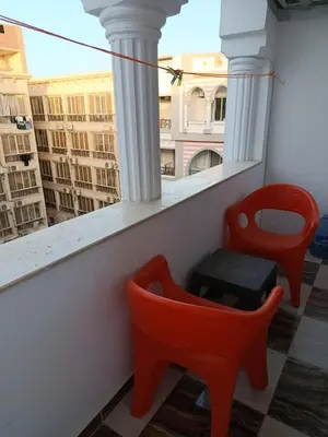 two red chairs on a balcony with a view at Sherathon studio Sheri in Hurghada