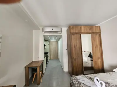 a bedroom with a bed and a desk and a mirror at Scandic Resort Hurghada App-C310 in Hurghada