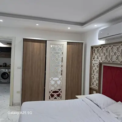 a bedroom with a bed and a sliding glass door at الغردقه in Hurghada