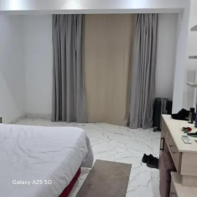 a hotel room with a bed and a desk at الغردقه in Hurghada