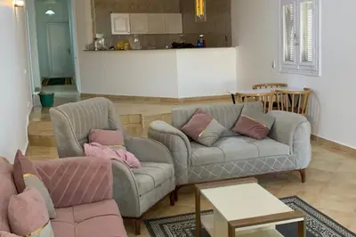 a living room with a couch and a table at Beachfront 3-Bed Sleeps 6 with Sea View in Hurghada