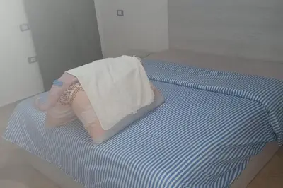 a doll laying on a bed with a blanket at Beachfront 3-Bed Sleeps 6 with Sea View in Hurghada