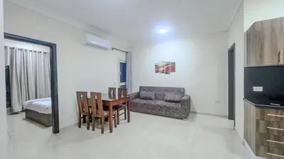 a living room with a table and a couch at La Quinta Beach Resort in Hurghada in Hurghada