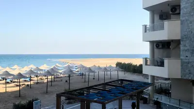 a view of a beach with umbrellas and the ocean at La Quinta Beach Resort in Hurghada in Hurghada
