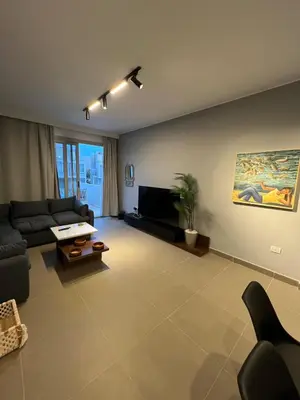a living room with a couch and a tv at Sholan El Gouna 2 Bedroom Apartment in Hurghada