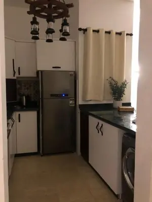 a kitchen with a stainless steel refrigerator in it at Chalet with private pool in Hurghada