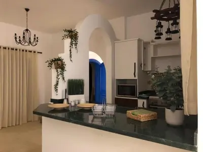 a kitchen with a black counter top in a room at Chalet with private pool in Hurghada