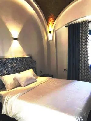 a bedroom with a large white bed in a room at Chalet with private pool in Hurghada