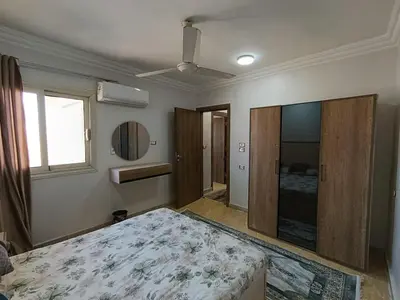 a bedroom with a large bed and a window at 3 Bedroom in Lotus in Naj‘ al Maḩaţţah