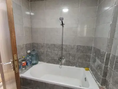 a bath tub in a bathroom with a shower at 3 Bedroom in Lotus in Naj‘ al Maḩaţţah