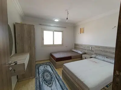 a small bedroom with two beds and a window at 3 Bedroom in Lotus in Naj‘ al Maḩaţţah
