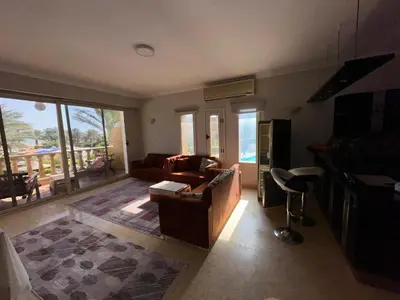 a living room with a couch and a table at cozy sea view apartment palma resort in Hurghada