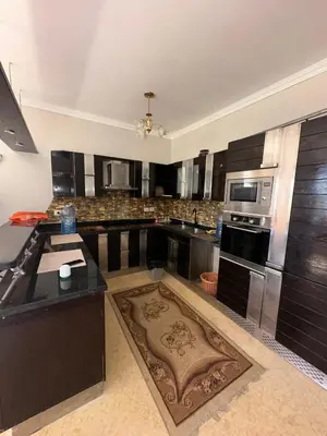 a large kitchen with black counters and stainless steel appliances at cozy sea view apartment palma resort in Hurghada