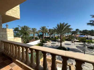 a view from a balcony of a resort with palm trees at cozy sea view apartment palma resort in Hurghada