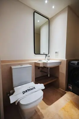a bathroom with a toilet and a sink and a mirror at Tranquil Terrace Studio at Ancient Sands in Hurghada